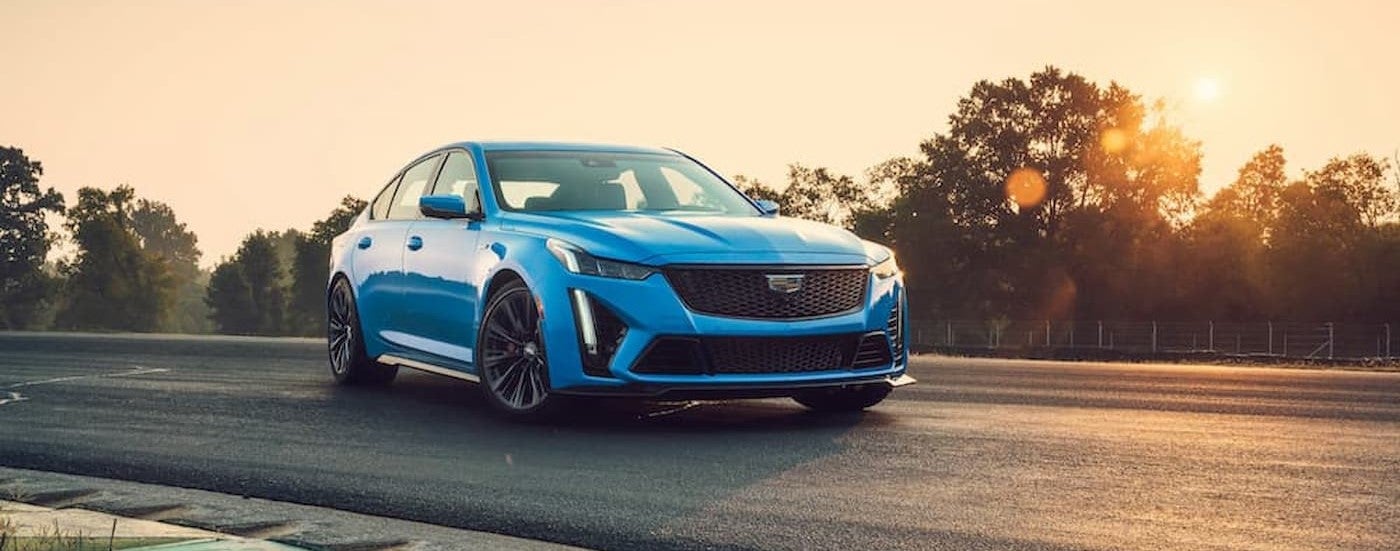 A blue 2023 Cadillac CT5-V Blackwing driving on a race track.