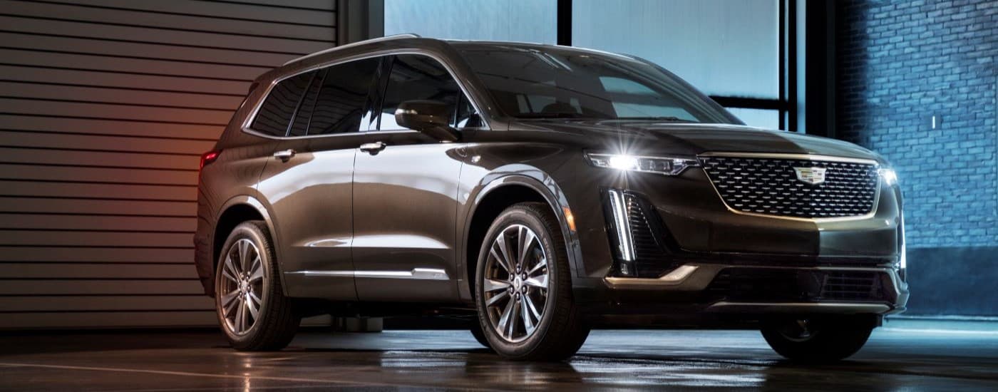 Marron 2020 Cadillac XT6 parked in front of a brick wall