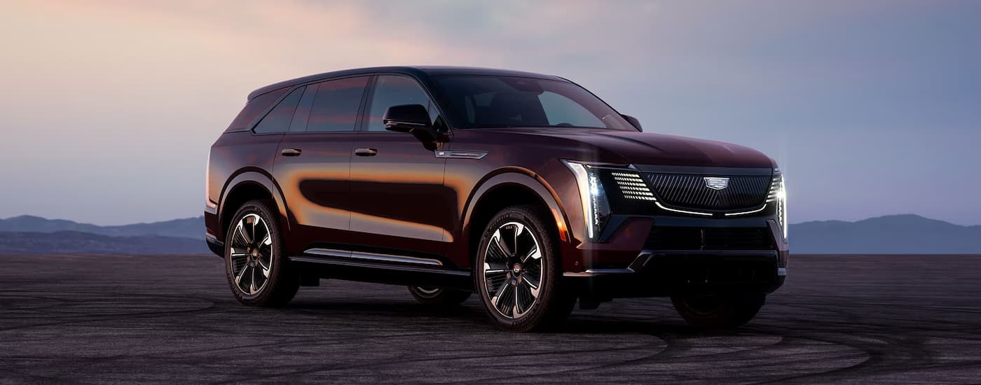 Dark purple 2026 Cadillac Escalade IQ parked in an open lot