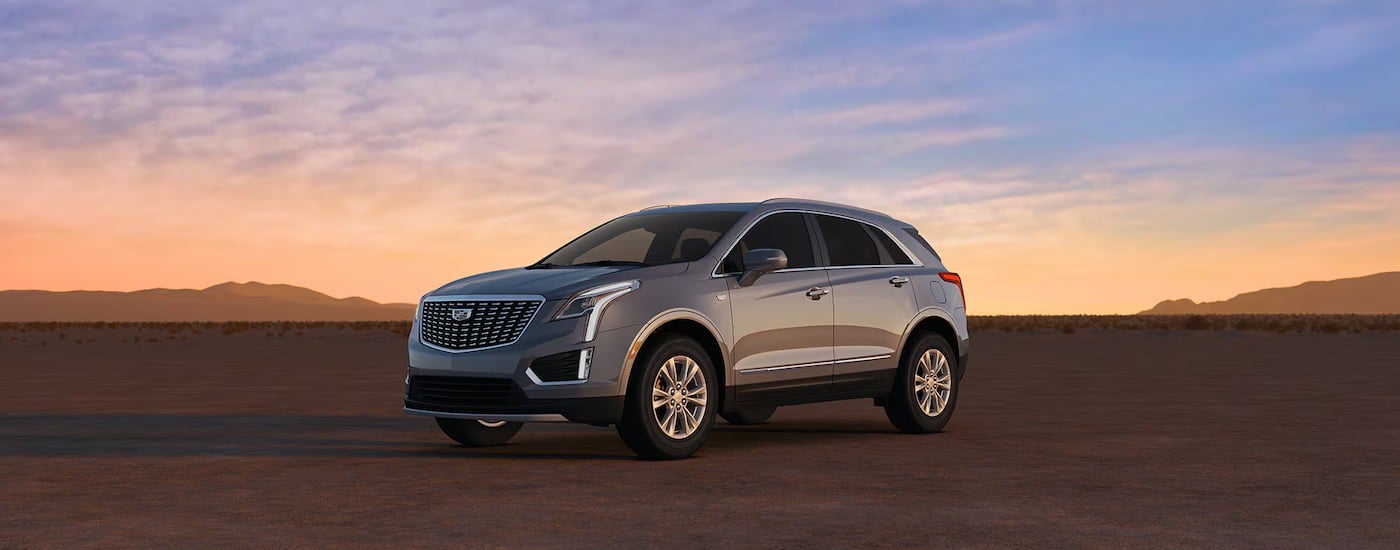 Grey 2026 Cadillac XT6 parked off-road in a desert.