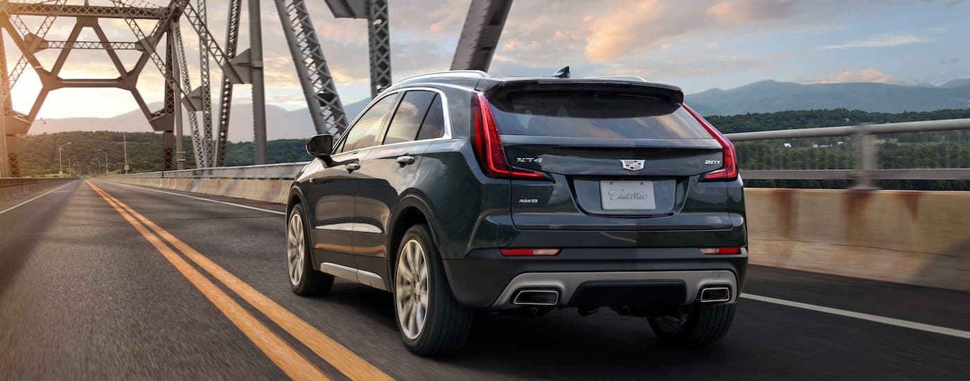 A blue 2020 Cadillac XT4 crossing a bridge.