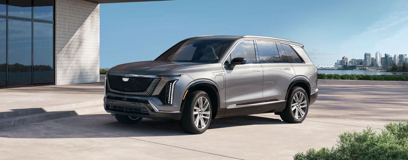 A silver 2027 Cadillac VISTIQ parked away from the city.