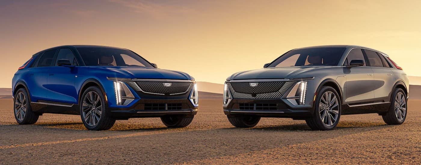 A blue and silver 2026 Cadillac LYRIQ facing each other.