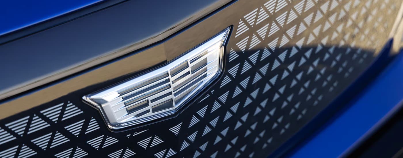 Close-up of grille and badge on a blue 2026 Cadillac VISTIQ.