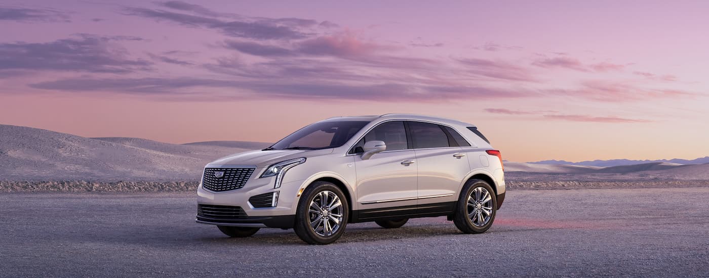 A white 2023 Cadillac XT5 from the side.