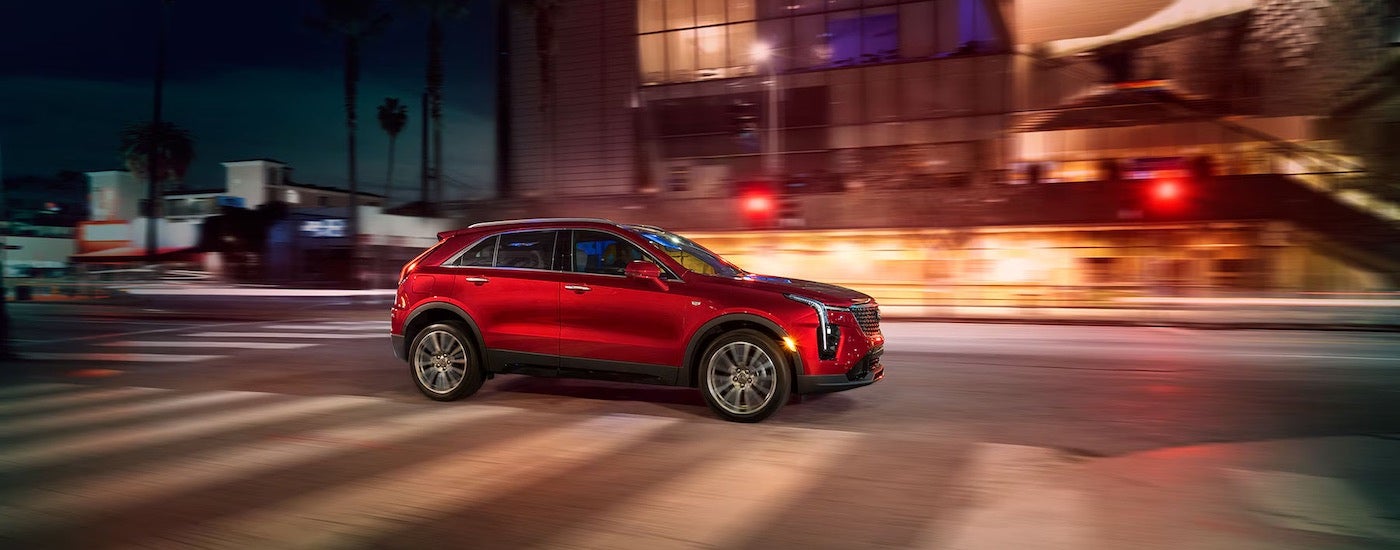 A red 2024 Cadillac XT4 from the side.